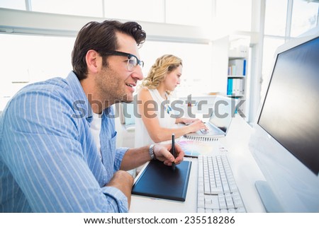 Graphic designer using a graphics tablet in his office