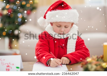 Festive little boy writing wish list against snow
