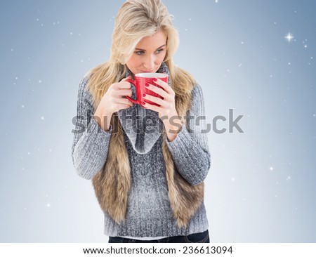 Woman in winter clothes holding a mug on vignette background