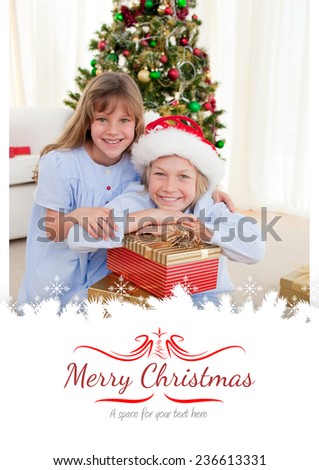 Happy brother and sister holding Christmas presents against border