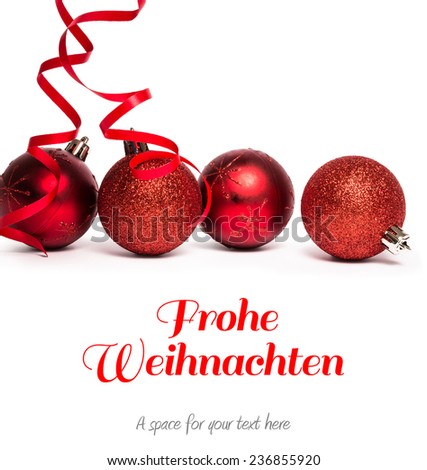Christmas greeting in german against four red christmas ball decorations
