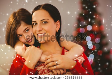 Festive mother and daughter smiling at camera against twinkling stars