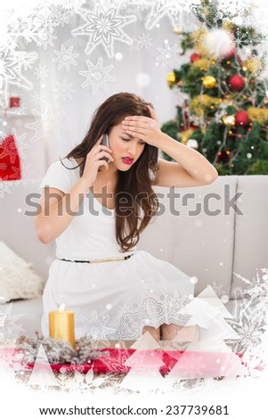 Concentrated brunette on the phone on christmas day against christmas theme frame in silver