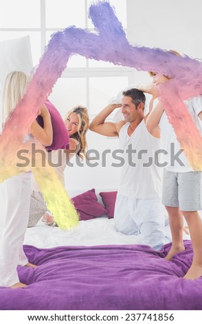 Family having fun with pillows against house outline in clouds