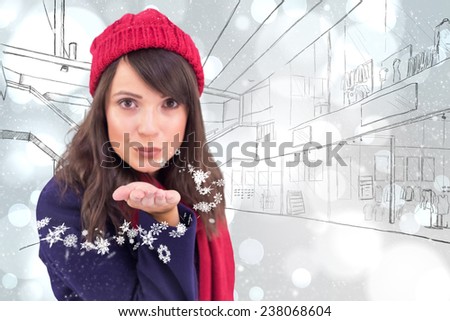 Festive brunette blowing a kiss against white glowing dots on grey
