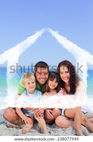 Portrait of a family at the beach against house outline in clouds