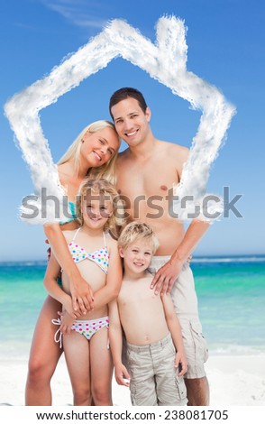 Happy family on the beach against house outline in clouds