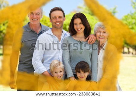 Family standing in the park against house outline in clouds