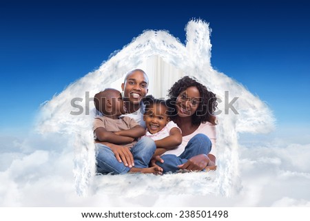 Happy family posing on the couch together against blue sky over clouds