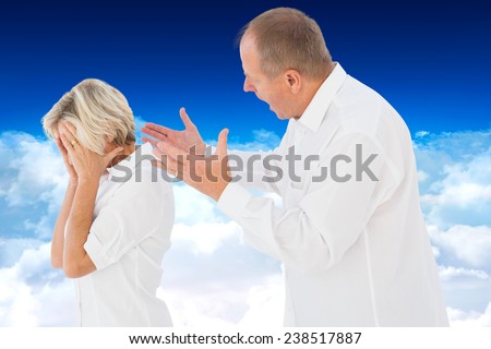 Angry man shouting at his partner against bright blue sky over clouds
