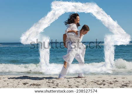 Woman sitting on man back and having fun against house outline in clouds
