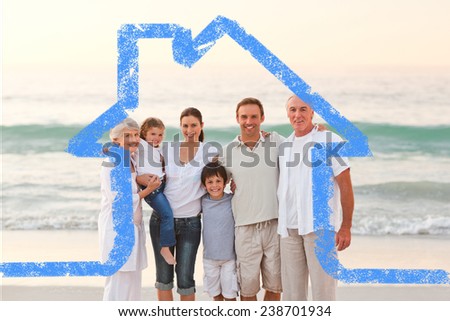 Beautiful family at the beach against house outline
