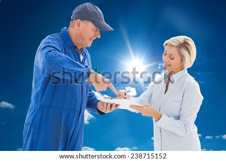 Happy delivery man with customer against cloudy sky with sunshine
