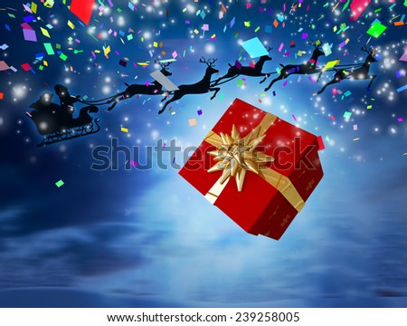 Santa flying his sleigh behind a big gift against snowy landscape