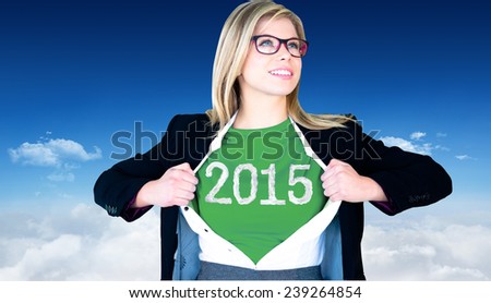 Businesswoman opening shirt in superhero style against bright blue sky over clouds