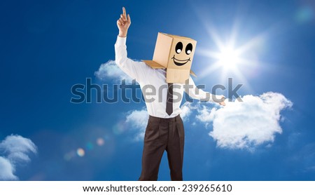 Anonymous businessman with arms out against bright blue sky with clouds