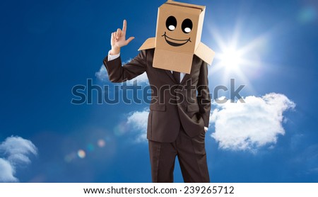 Anonymous businessman pointing up with finger against bright blue sky with clouds