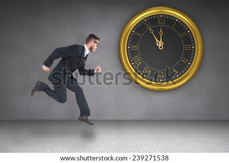 Geeky young businessman running mid air against grey room