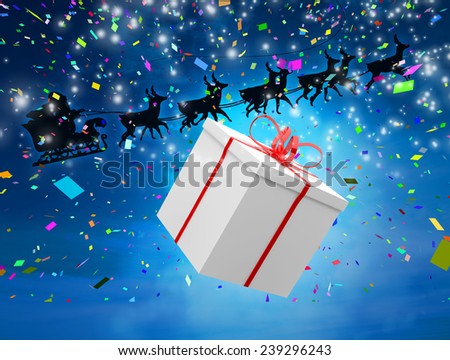 Santa flying his sleigh behind a big gift against blue sky