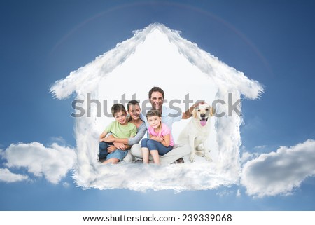 Cute family with pet labrador posing and smiling at camera together against cloudy sky with sunshine