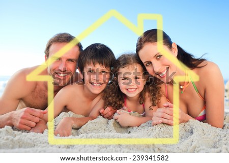 Family at the beach against house outline