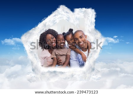 Happy family posing on the couch together against bright blue sky over clouds