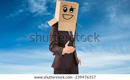 Anonymous businessman offering his hand against blue sky