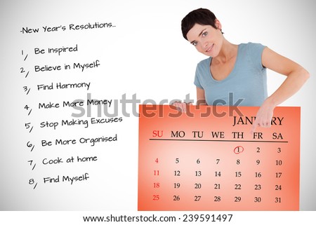 Smiling woman pointing at calendar on a panel against orange card