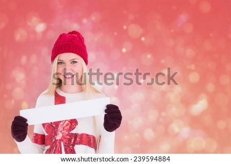 Festive blonde showing a blank banner against red abstract light spot design
