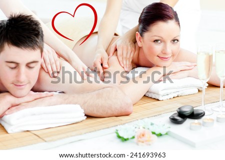 Attractive young couple enjoying a back massage against heart