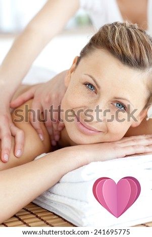 Cheerful woman enjoying a back massage against heart