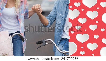 Hip young couple going for a bike ride against heart pattern