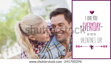 Man giving his pretty girlfriend a piggy back against valentines day greeting