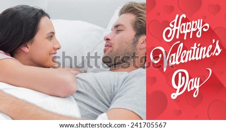 Couple awaking and looking at each other against cute valentines message