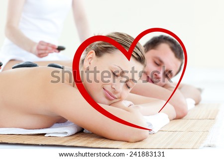 Young couple having a massage with hot stone against heart