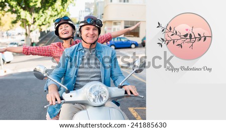 Happy mature couple riding a scooter in the city against love birds