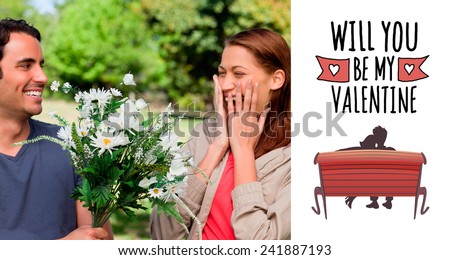 Young woman holding her hands against her face when presented with flowers against cute valentines message