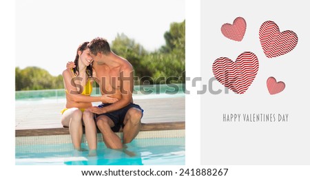 Gorgeous couple sitting poolside on holidays against cute valentines message