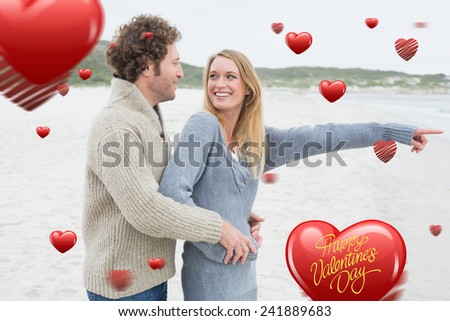 Side view of a relaxed romantic couple at beach against happy valentines day