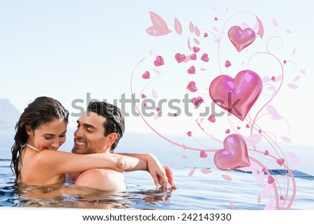 Couple hugging in the pool against valentines heart design