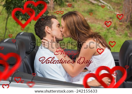Beautiful couple kissing in back seat against cute valentines message