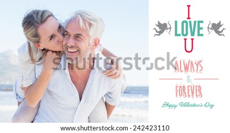 Man giving his smiling wife a piggy back at the beach against i love you message