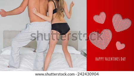 Low section of a semi dressed couple on bed against cute valentines message