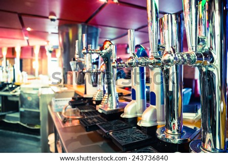 Shiny beer taps in a row in a bar