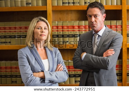 Lawyers looking at camera in the law library at the university