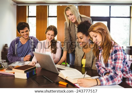Professor teaching group of students in library at the university