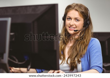 Student sitting at the computer room wearing headset at the university