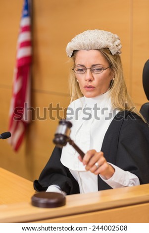 Stern judge sitting and listening in the court room