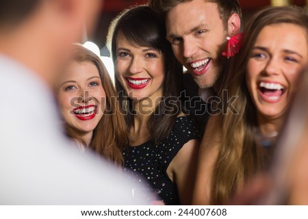 Drunk friends laughing with barman at the nightclub