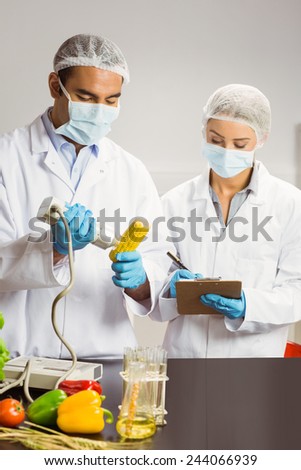 Food scientist using device on corn cob at the university